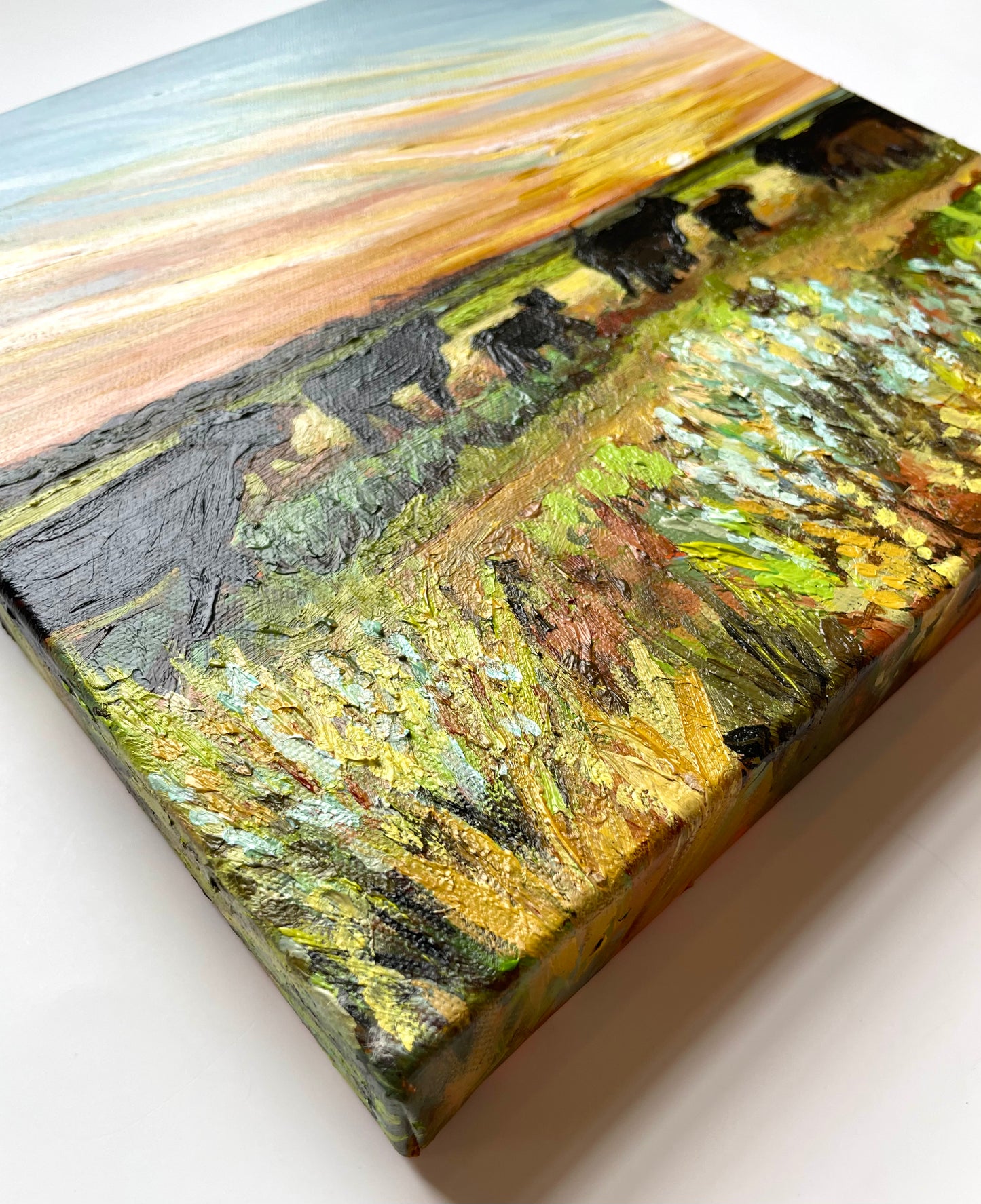 Painting of cows in a field with a textured surface
