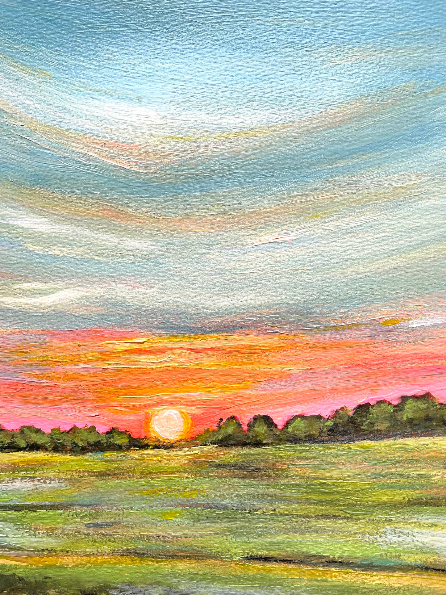Painting of a sunset over a field with green trees