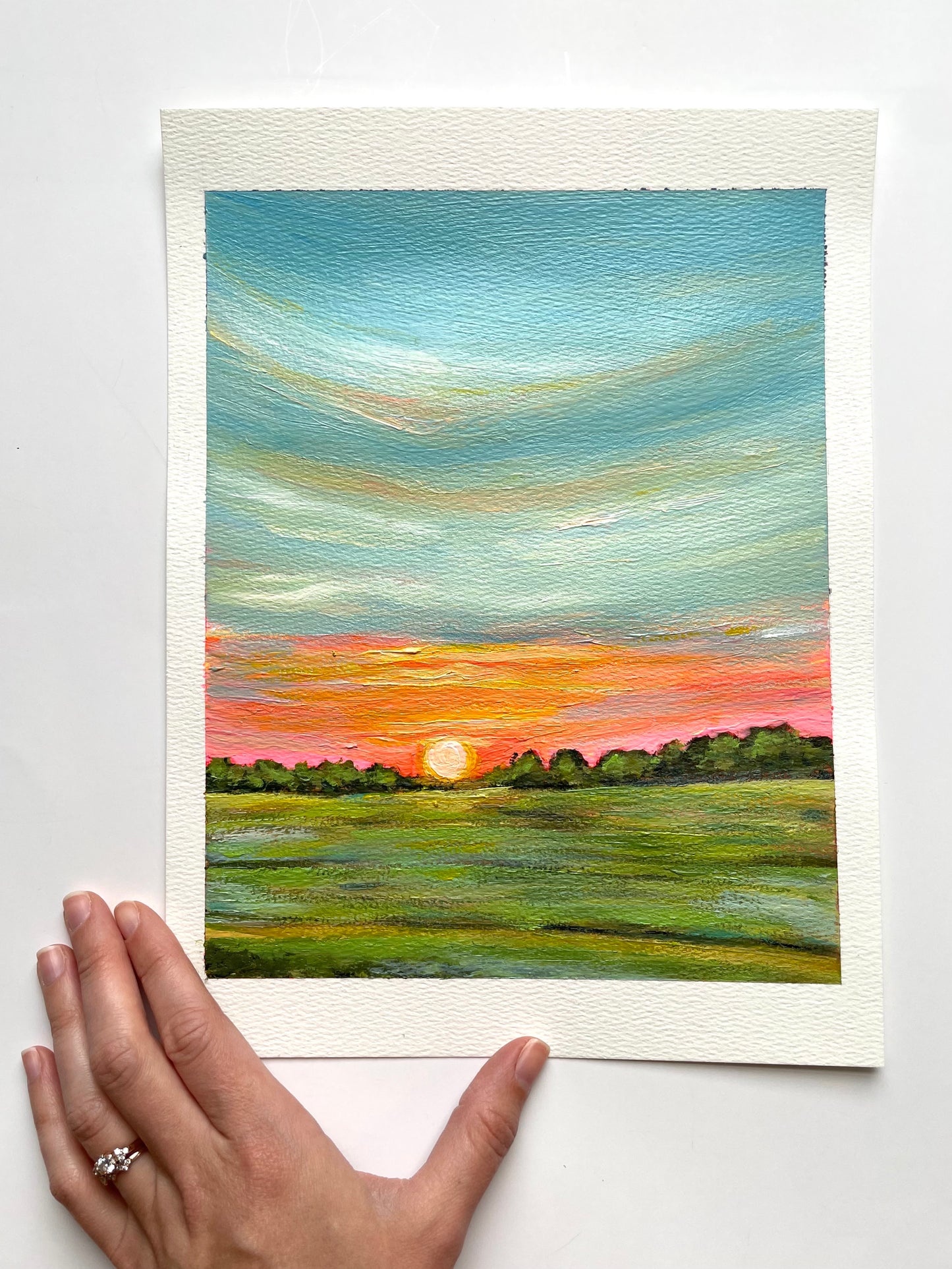 Kansas Sunrise Painting with neon skies and bright green grass. Paper size 8x10. Painting by Artist Nicole May Lesher