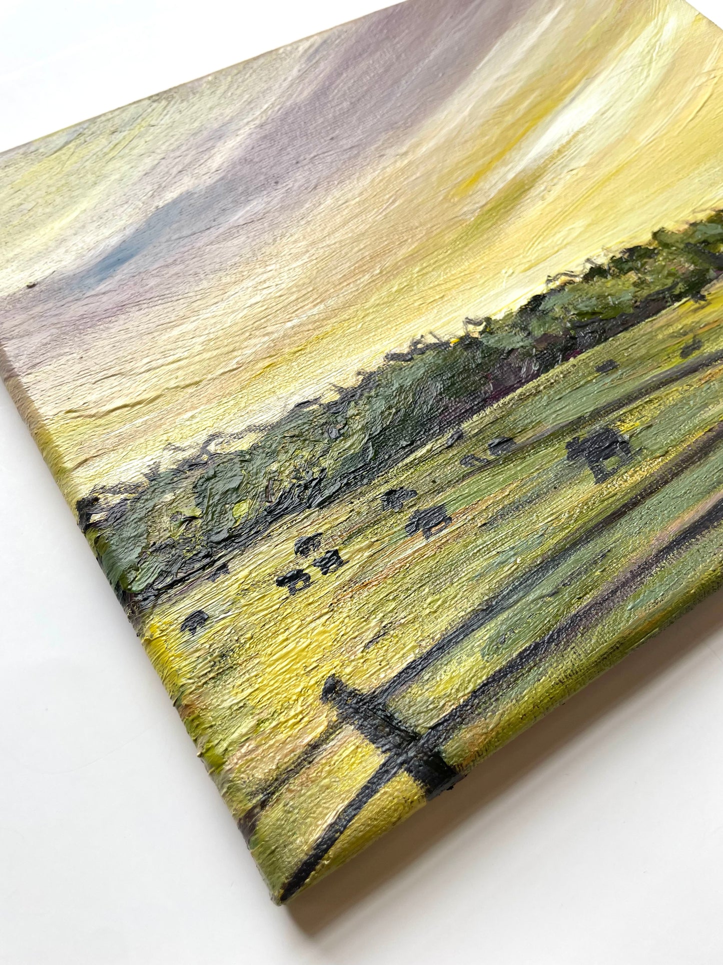 Abstract impressionist painting with yellow, green, and black on a white background